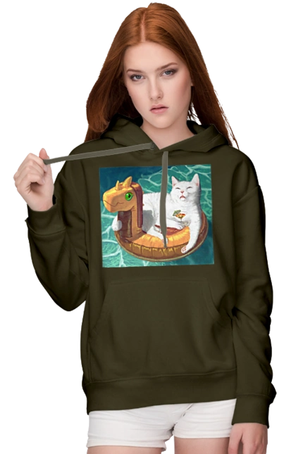 Білий кіт у плавальному колі, на відпочинку