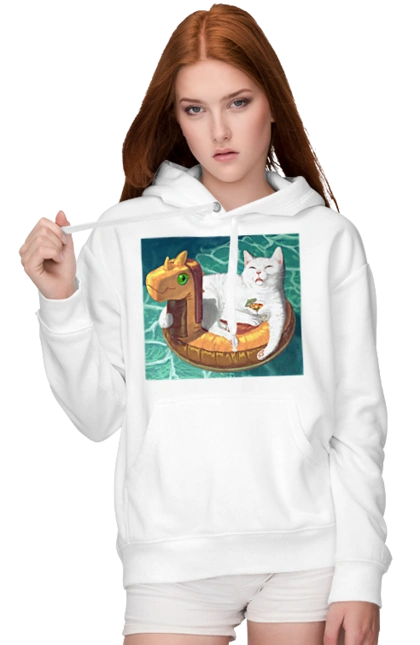 White cat in a swimming circle on vacation